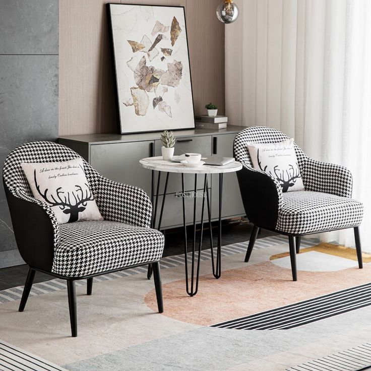Pair of houndstooth lounge armchairs with marble side table