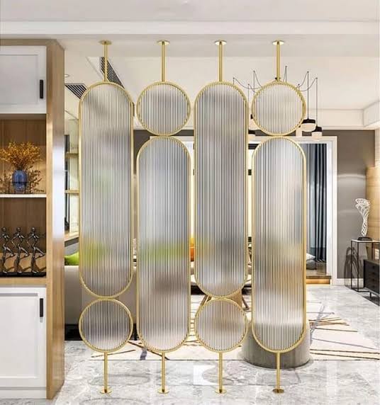 Brushed gold PVD metal frames of fluted glass partition showing metal finish