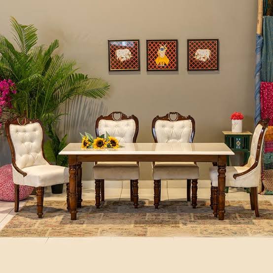 Compact white marble four-seater dining table with turned wood legs